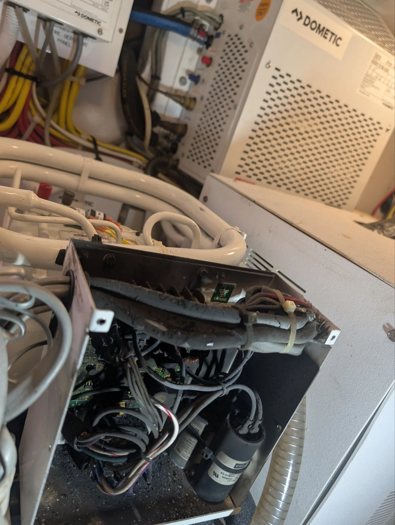Opened Dometic marine HVAC electrical compartment with visibly heat-damaged wiring