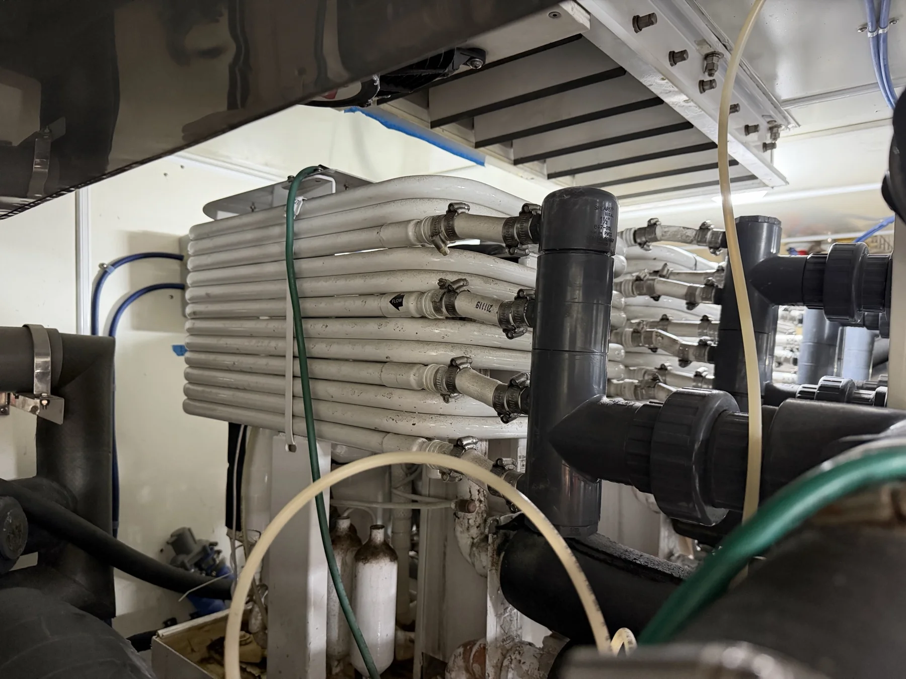 Stacked marine heat exchangers connected to black system piping