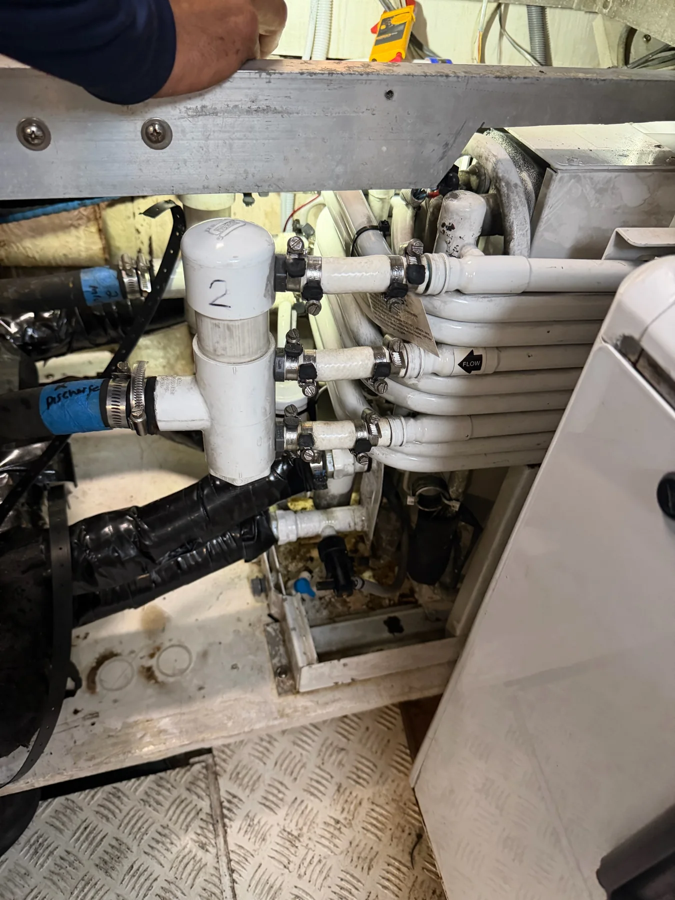 Marine HVAC seawater manifold and cooling-circuit plumbing installed in a machinery space
