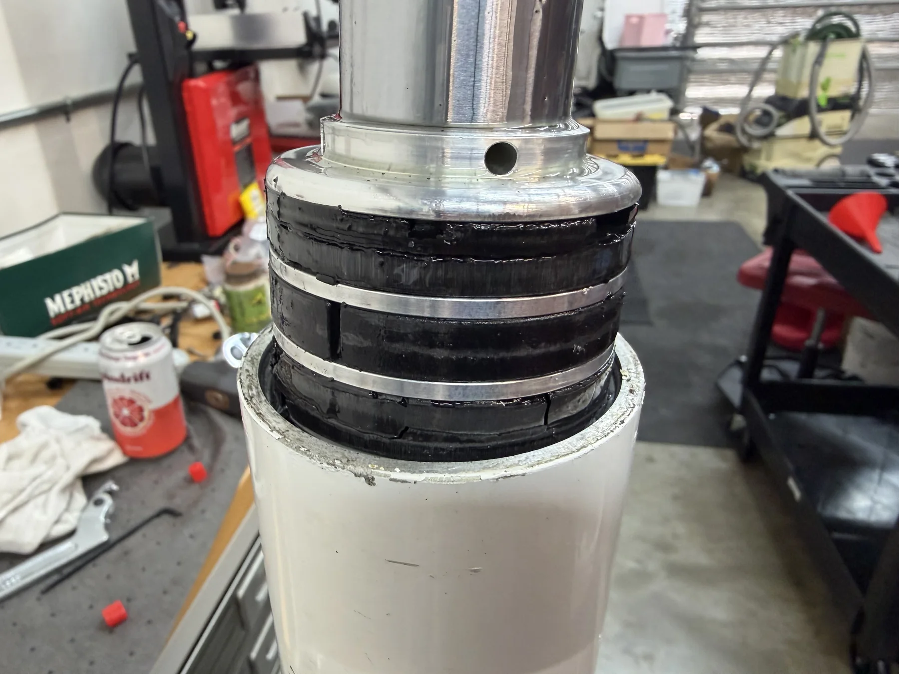 Hydraulic cylinder piston showing damaged seals during workshop disassembly