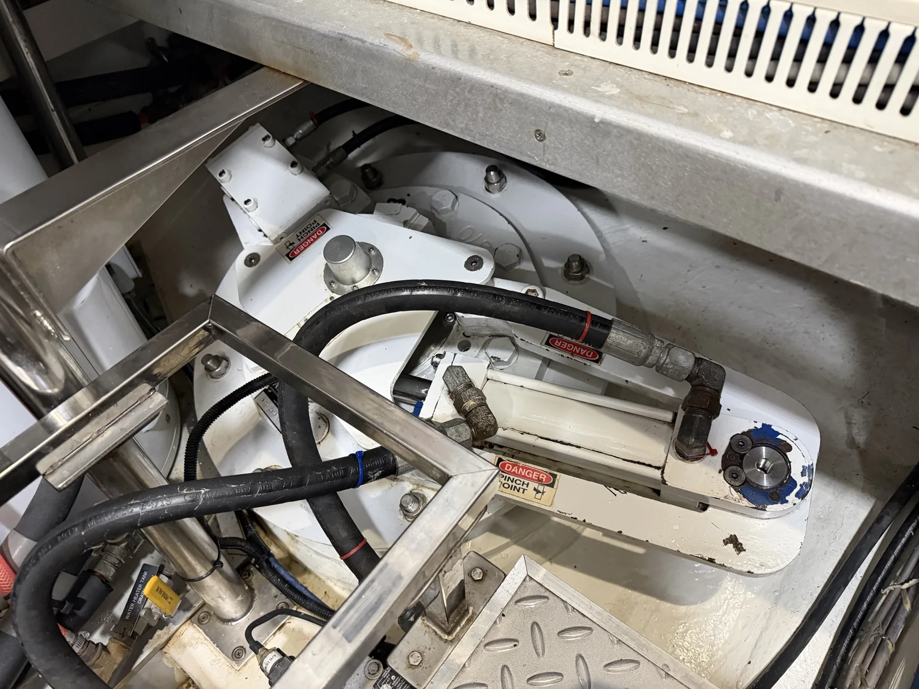 Installed marine stabilizer actuator with hydraulic cylinder, linkage, and hoses